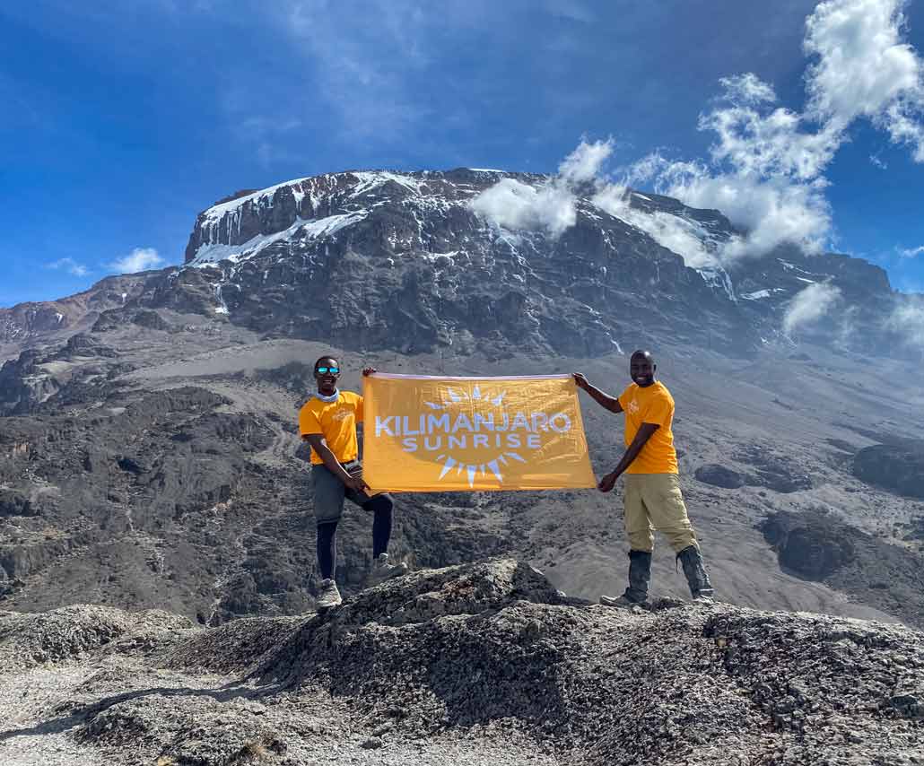 guides-slide Kilimanjaro Sunrise guides with flag