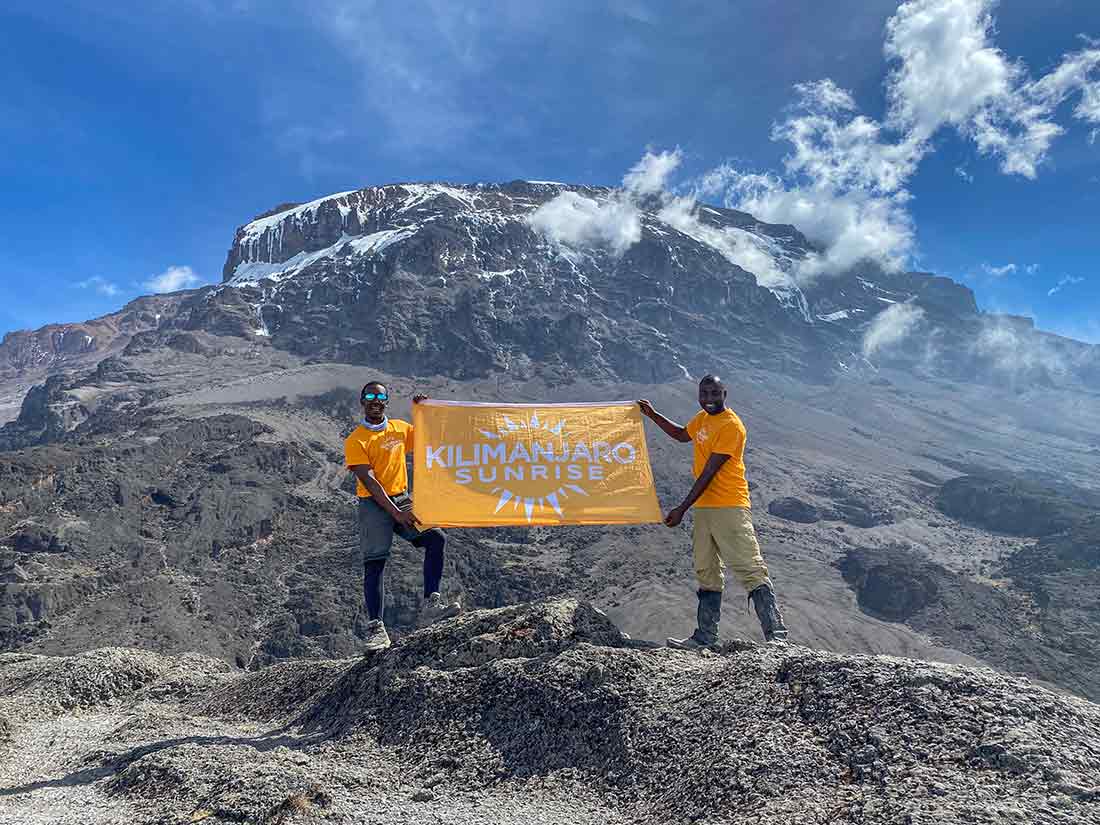 Guides with Kilimanjaro Sunrise flag
